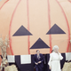 President George H. W. Bush and wife Barbara, emerge from a giant pumpkin on the South Lawn of the White House Oct. 31, 1989 in Washington, where they hosted a Halloween party for local school kids. Photo via AP Images.